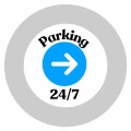 szkiełko gobo, czarny napis: parking 24/7, po środku grafiki biała strzałka w prawo, na niebieskim, okrągłym tle